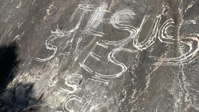 Vandals have carved ‘Jesus Saves Just Ask Him’ into a rock with significance to the Jinibara People. Picture: DES