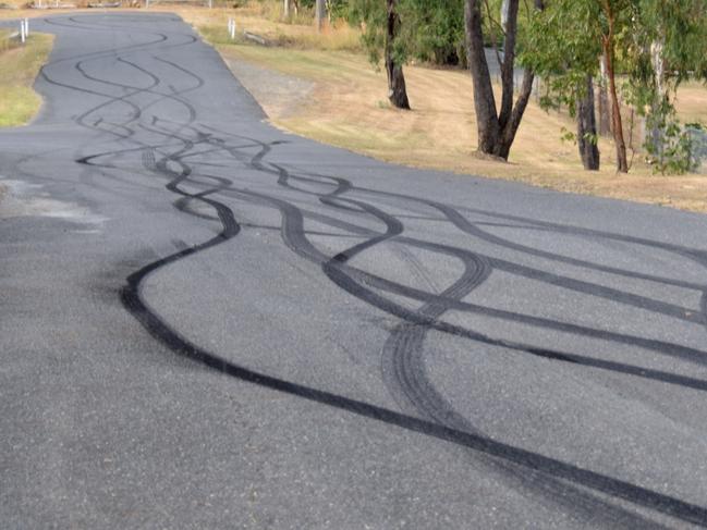 The condition of the road outside Rockhampton Memorial Gardens following mourners' burn outs