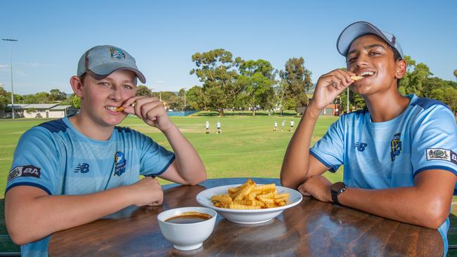 Charlie Dawson and Arjun Sareen with a bowl of chips and gravy pictured at the Goodwood Cricket Ground. Picture: Ben Clark