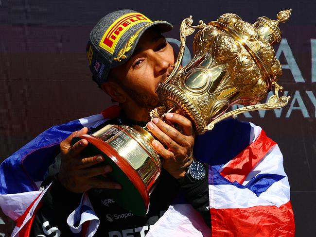 NORTHAMPTON, ENGLAND - JULY 07: Race winner Lewis Hamilton of Great Britain and Mercedes celebrates on the podium during the F1 Grand Prix of Great Britain at Silverstone Circuit on July 07, 2024 in Northampton, England. (Photo by Mark Thompson/Getty Images) *** BESTPIX ***