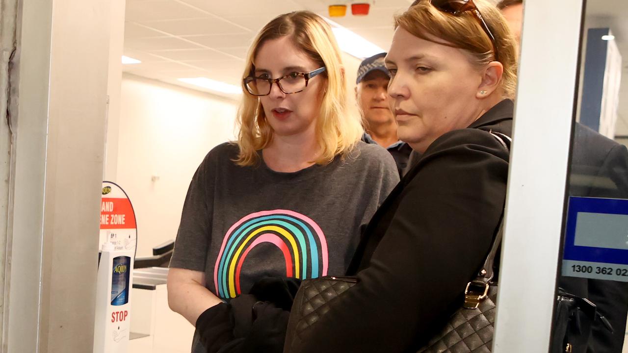 Lisa Lines escorted by police after being extradited back to Australia on charges of attempted murder. Picture: Kelly Barnes