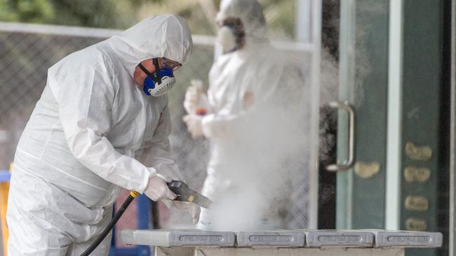 Workers sanitise Kensington Primary School, which was shut down on Friday. Picture: Jake Nowakowski