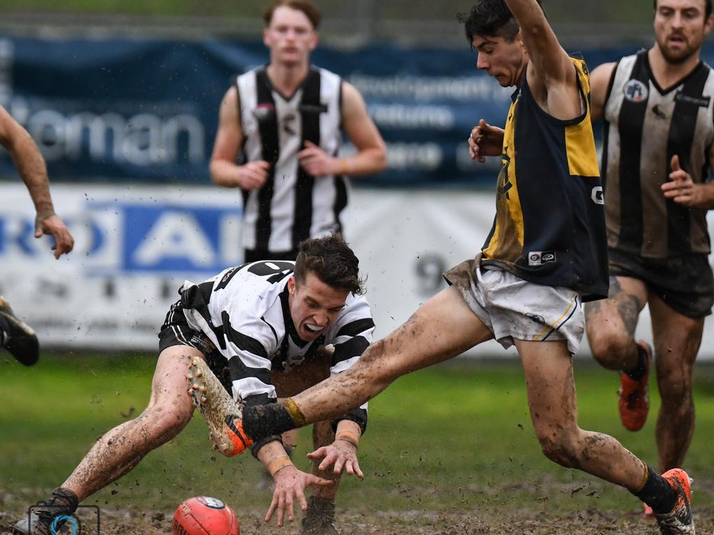 A Montmorency player shows courage to try to stop a kick off the ground during his side’s clash with Hurstbridge. Pictures: Nathan McNeill.