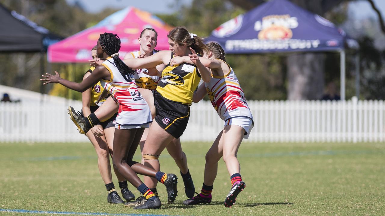 Charlotte Artavilla-Bennett gets a kick away for Toowoomba Tigers against University Cougars in AFL Darling Downs Toowoomba Toyota Cup senior women grand final at Rockville Park, Saturday, September 2, 2023. Picture: Kevin Farmer