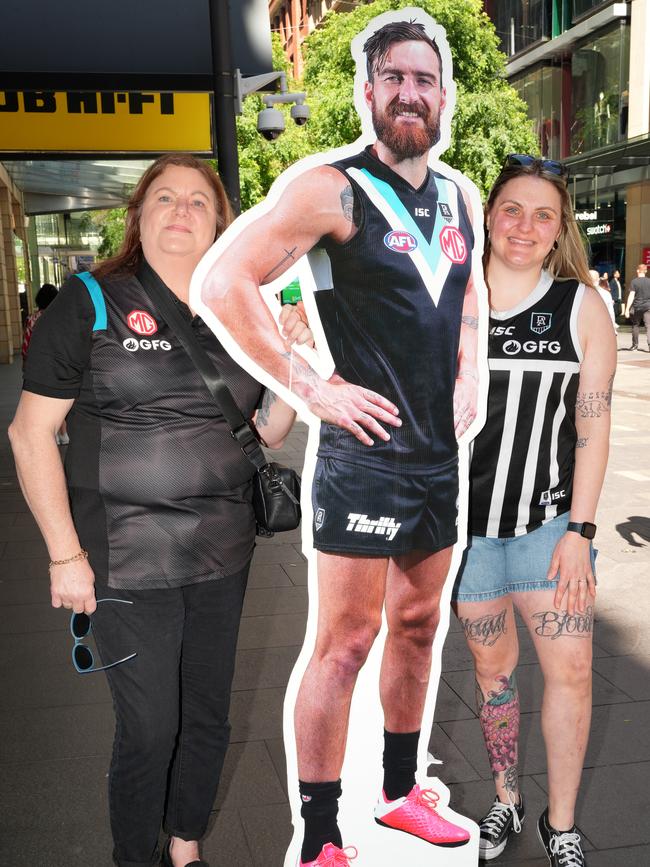 Port fans Leanne (left) and Sarah Goldsmith, from Adelaide, were well aware who Charlie is when they bumped into him in Sydney’s Pitt Street Mall on Thursday. Picture: Dean Martin