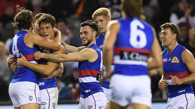 Bulldogs players celebrate a Josh Dunkley goal against the Blues in Round 13.