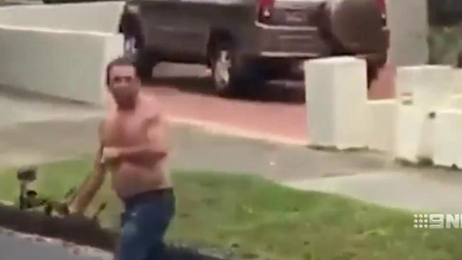 Shocking footage shows a shirtless man with a bow and arrow in Randwick. Picture: 9News