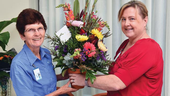 Marcia Begg is presented with a bouquet of flowers by Mater Mackay executive officer Elizabeth Thomas. Picture: Tony Martin