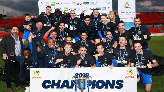 Adelaide Olympic players and staff celebrate after downing Adelaide City in the FFA Cup SA final at Hindmarsh Stadium. Picture: AAP/Emma Brasier