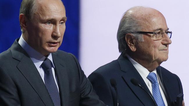 Russian President Vladimir Putin, left, speaks as FIFA President Sepp Blatter listens during the preliminary draw for the 2018 soccer World Cup in Konstantin Palace in St. Petersburg, Russia, Saturday, July 25, 2015. (AP Photo/Dmitry Lovetsky