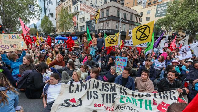 Demonstrators stage a sit-in on a road during a Extinction Rebellion protest in Melbourne in 2019.