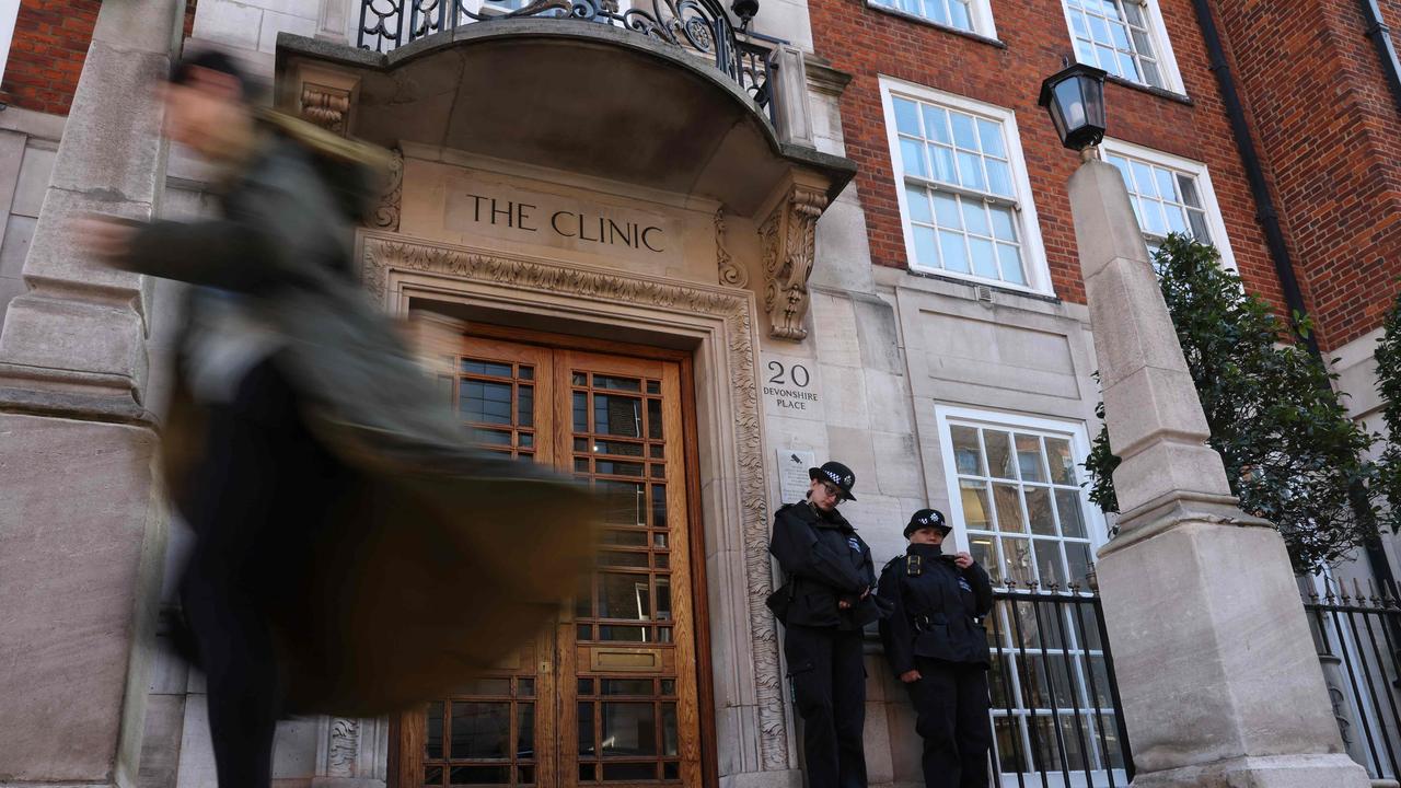 Police officers stand guard outside the London Clinic in London where King Charles is staying. Picture: AFP