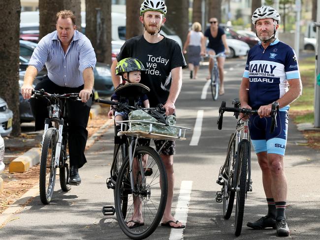 Dave Musgrove with son Bob, 13 months, and Jim Buda from the Manly Warringah Cycle Club are concerned about helmet laws. Picture: Troy Snook