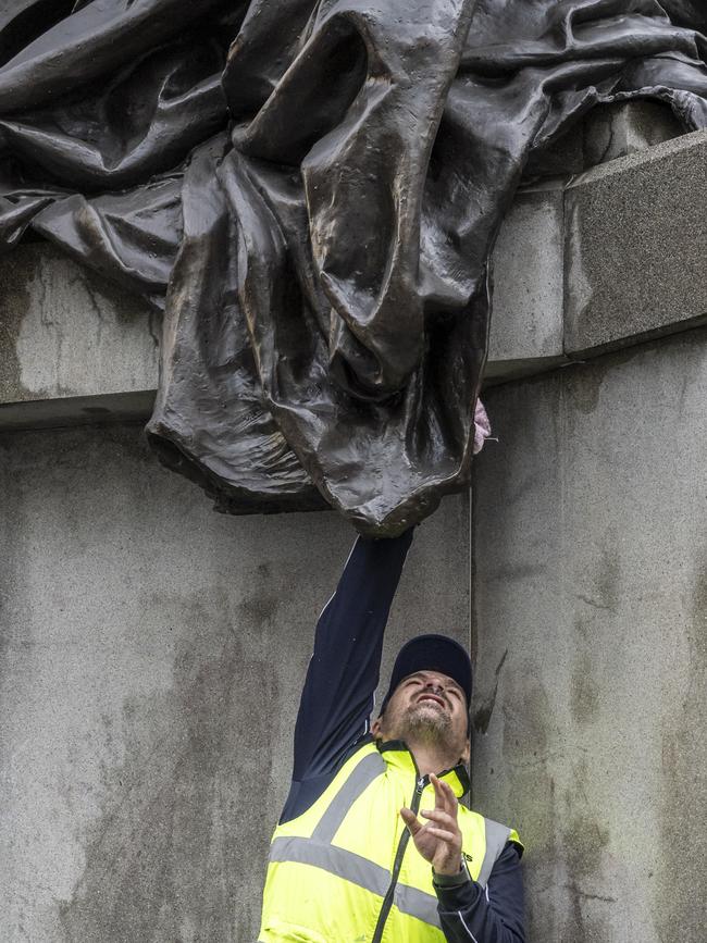 Cleaners worked to clean the iconic statue of Queen Victoria on Tuesday. Picture: NewsWire / Monique Harmer