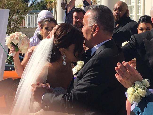 The father of the bride embraces his daughter.