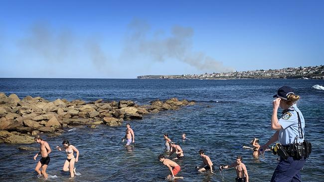 Swimmers who defied social-distancing rules at Sydney’s Clovelly are ordered out of the water. Picture: Getty Images