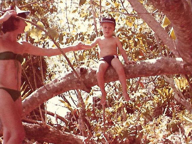 John as a toddler in a bush setting