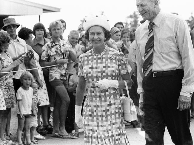 Families lines the streets to catch a glimpse of their Royal Majesty. The Queen is pictured with Former Administrator of the Northern Territory John England.