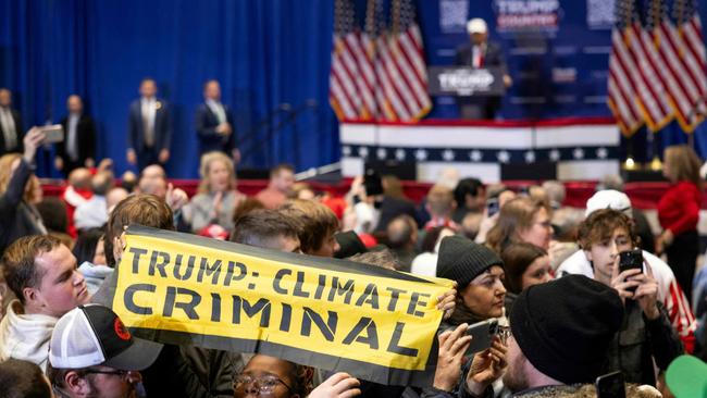 Climate protesters interrupted Donald Trump as he spoke at a "commit to caucus rally" in Indianola, Iowa. Picture: AFP