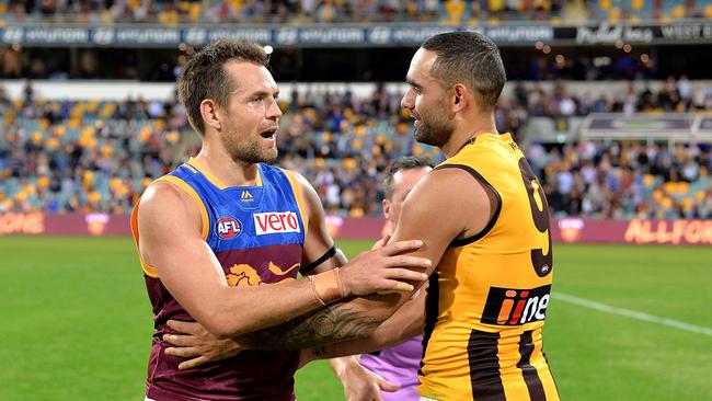 Hawthorn legend turned Brisbane star Luke Hodge reunites with Shaun Burgoyne after their match at the Gabba last month. Picture: Bradley Kanaris/Getty Images