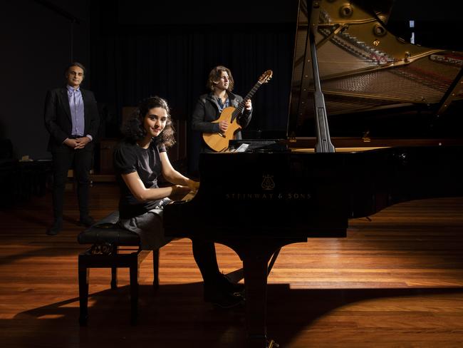 Kim Cunio (l), Associate Professor at the School of Music of The Australian National University, with music students, Roya Safaei and Dante Clavijo in Llewellyn Hall, Canberra. Picture: Sean Davey