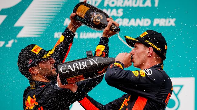 Red Bull teammates Max Verstappen and Daniel Ricciardo celebrate on the podium after the Malaysian GP.