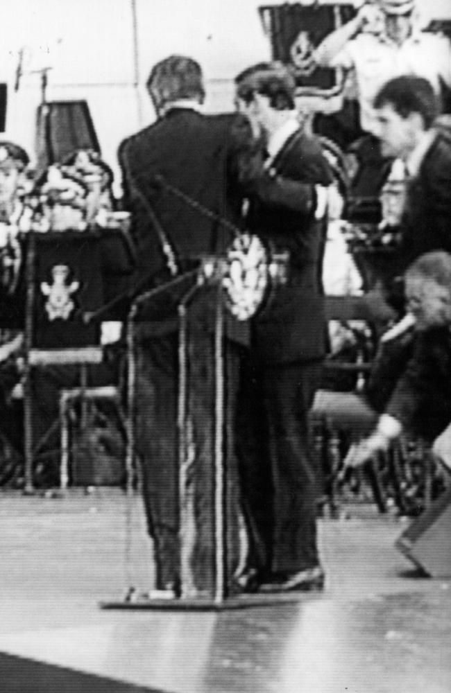 1994: The next day, a gunman opened fire during Prince Charles’ Australia Day address in Sydney. The royal is seen here being ushered off the stage.