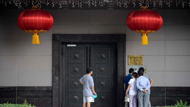 People attempt to talk to someone at the Chinese consulate in Houston. Picture: AFP