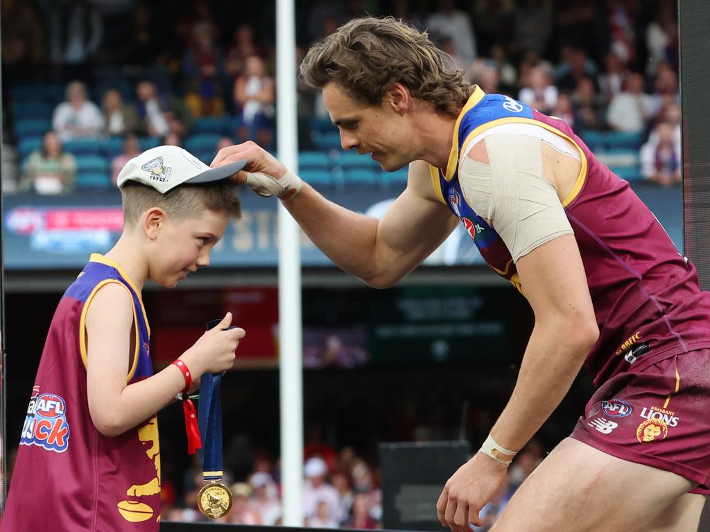 Joe Daniher receives his premiership medal on the dais. Picture Lachie Millard