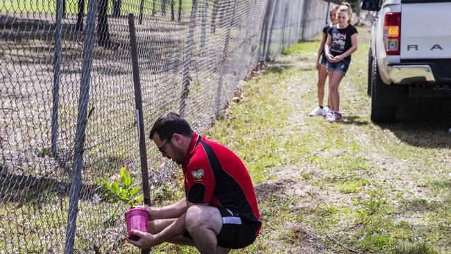 A man who would only give his name as Mark plants a tribute at crash site. Picture: Jenny Evans