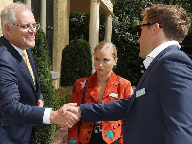 Grace Tame appeared unimpressed as the Prime Minister shook hands with her partner. Picture: NCA NewsWire / Gary Ramage