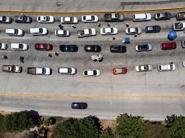 Cars line up to cross to the US at the San Ysidro crossing port in Tijuana. Picture: AFP