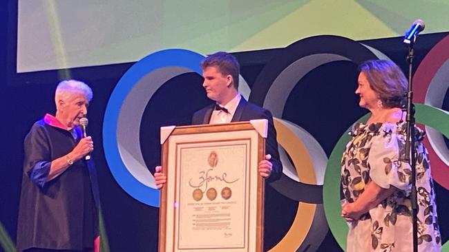 Former Olympian Dawn Fraser presents Gina Rinehart with her Olympic Gold Medals.