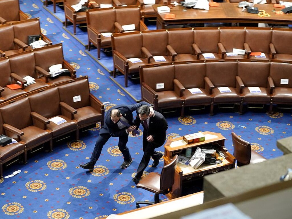 Members of Congress ran for cover as protesters breached the US Capitol Building. Picture: Getty Images