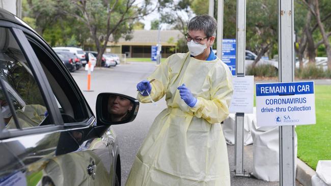 A patient is tested by an SA Pathology nurse at the new Hampstead drive-through clinic. Picture: AAP / Brenton Edwards