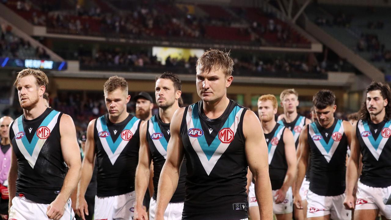 Ollie Wines and his team mates walk off the oval. Photo by Sarah Reed/AFL Photos via Getty Images.