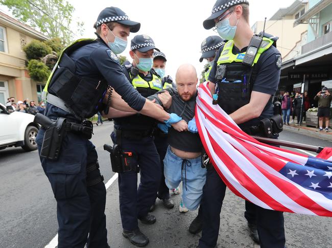 A barber in Hughesdale has opened today with lines out the door despite Victoria's stage four COVID-19 restrictions. Adam and Weave Barber Shop took to social media last night posting they would be open for business from 8.30am today. A supporter is arrested .  .Picture: Alex Coppel.