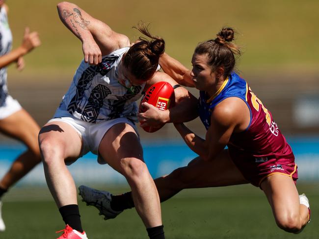 MELBOURNE, AUSTRALIA - MARCH 14: Brianna Davey of the Magpies is tackled by Catherine Svarc of the Lions during the 2021 AFLW Round 07 match between the Brisbane Lions and the Collingwood Magpies at Victoria Park on March 14, 2021 in Melbourne, Australia. (Photo by Michael Willson/AFL Photos via Getty Images)