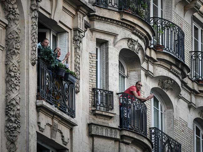 Residents applaud health workers in Paris. Picture: AFP.