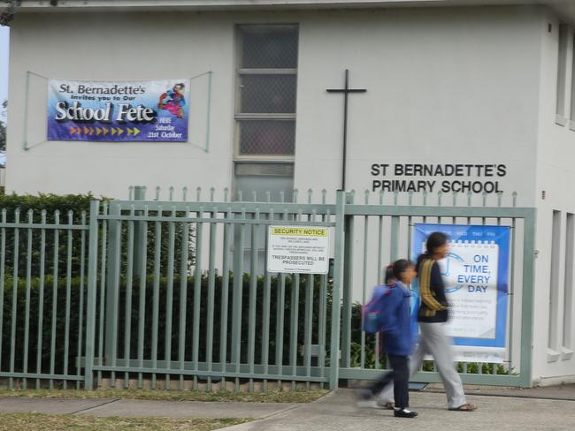 Parents and children outside the school. Picture: John Grainger