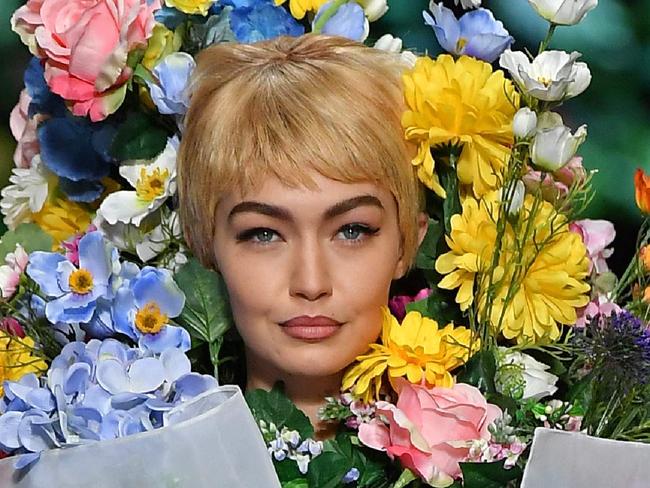 Model Gigi Hadid presents a creation for fashion house Moschino during the Women's Spring/Summer 2018 fashion shows in Milan, on September 21, 2017.  / AFP PHOTO / Marco BERTORELLO