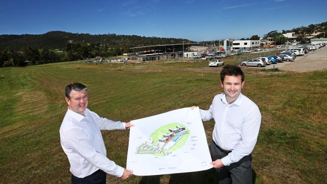 Traders In Purple CEO Brett Robinson, left, and Kingborough Mayor Dean Winter with the master plan concept for the Kingston High School site redevelopment. Picture: CHRIS KIDD