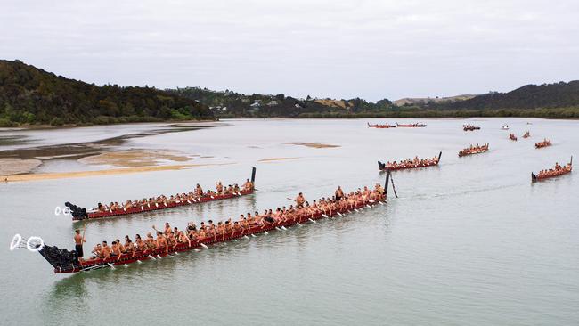 Traditional waka paddle down the Waitangi River on Waitangi Day. Picture: AAP.