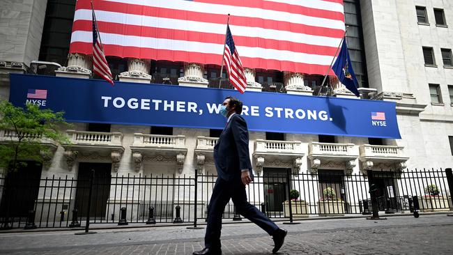 A man walks past the New York Stock Exchange, where US stocks fell heavily overnight. Picture: AFP