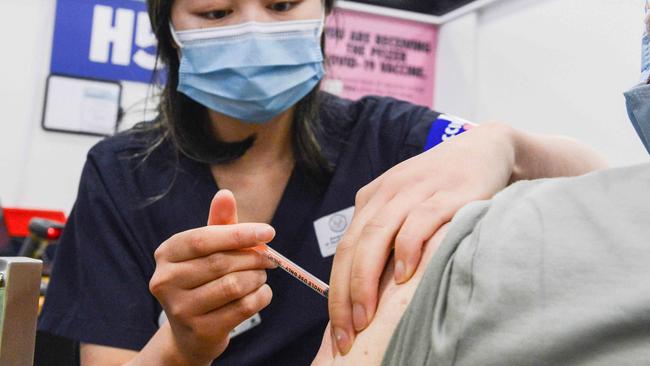 ADELAIDE, AUSTRALIA - NewsWire Photos NOVEMBER 4, 2021: SA Health vaccinator Xuan gives paramedic Sharon Hennessy a Covid booster vaccine at Wayville Vaccination Clinic. Picture: NCA NewsWire/Brenton Edwards