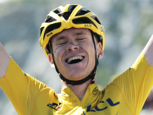 Britain's Christopher Froome, wearing the overall leader's yellow jersey, celebrates as he crosses the finish line to win the tenth stage of the Tour de France cycling race over 167 kilometers (103.8 miles) with start in Tarbes and finish in La Pierre-Saint-Martin, France, Tuesday, July 14, 2015. (AP Photo/Christophe Ena)