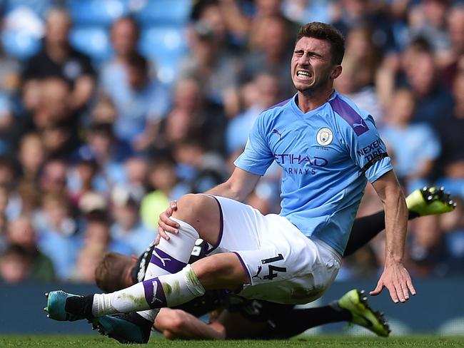 Manchester City's French defender Aymeric Laporte picks up an injury in a challenge with Brighton's English defender Adam Webster. Picture: Oli Scarff/AFP