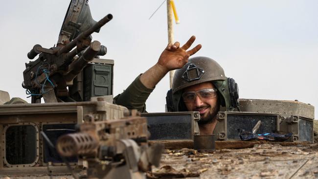 An Israeli soldier gestures from a battle tank in southern Israel near the border with the Gaza Strip. Picture: AFP