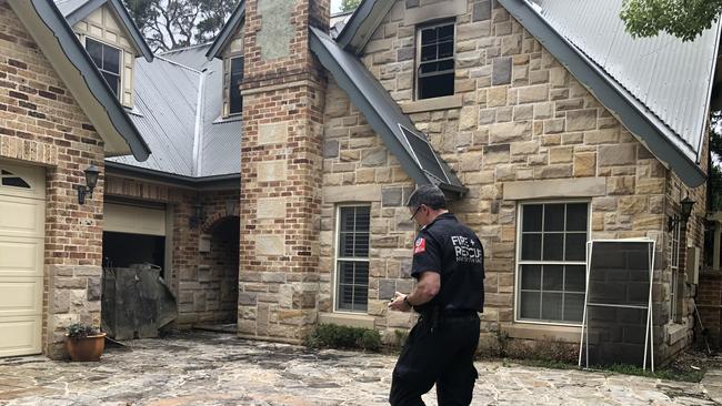 NSW Fire and Rescue's investigator Michael Forbes at the Whitehaven Rd, Northmead, house that was destroyed by fire on Sunday.