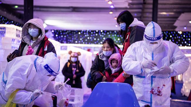 Health workers collected samples to be tested for the coronavirus that causes Covid-19 at an ice and snow theme park in Wuhan in December. Picture: AFP